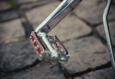 a close up of a bike handlebar with a red and white pattern