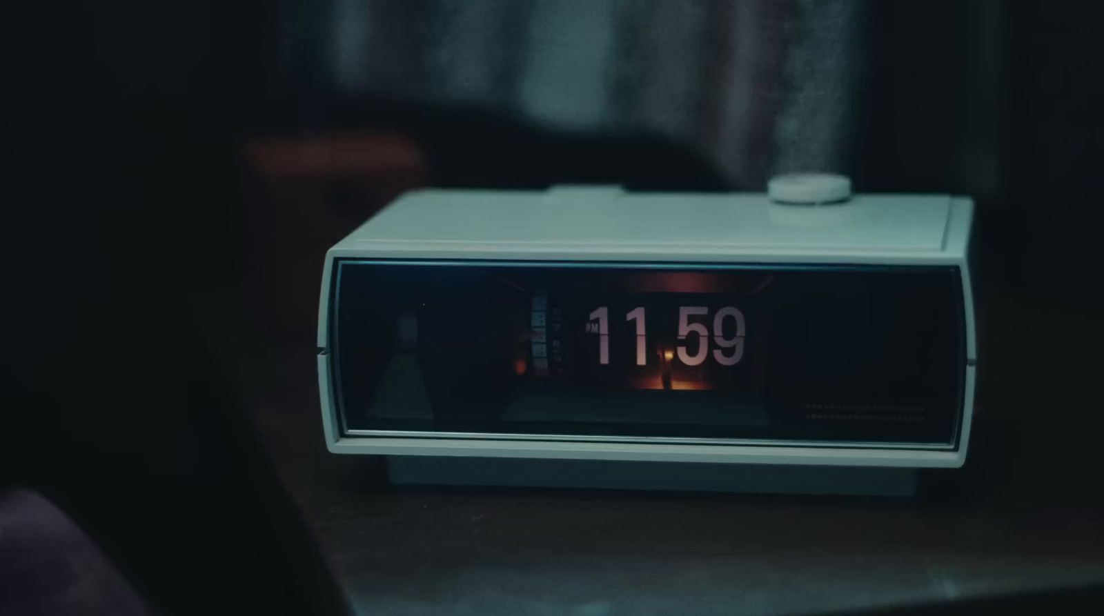 an alarm clock sitting on top of a table