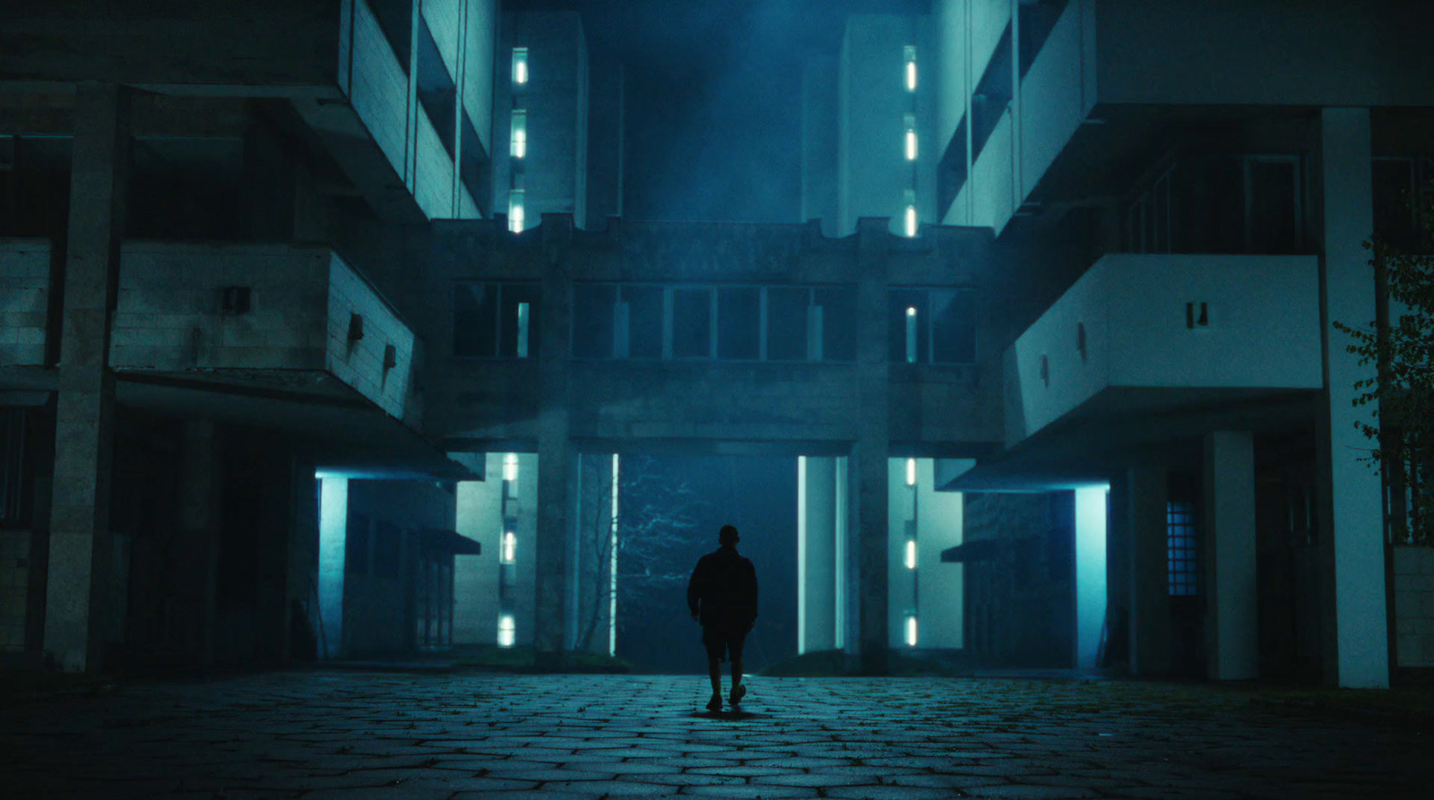 a man standing in an empty building at night