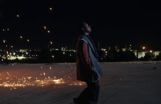 a man standing in the middle of a street at night