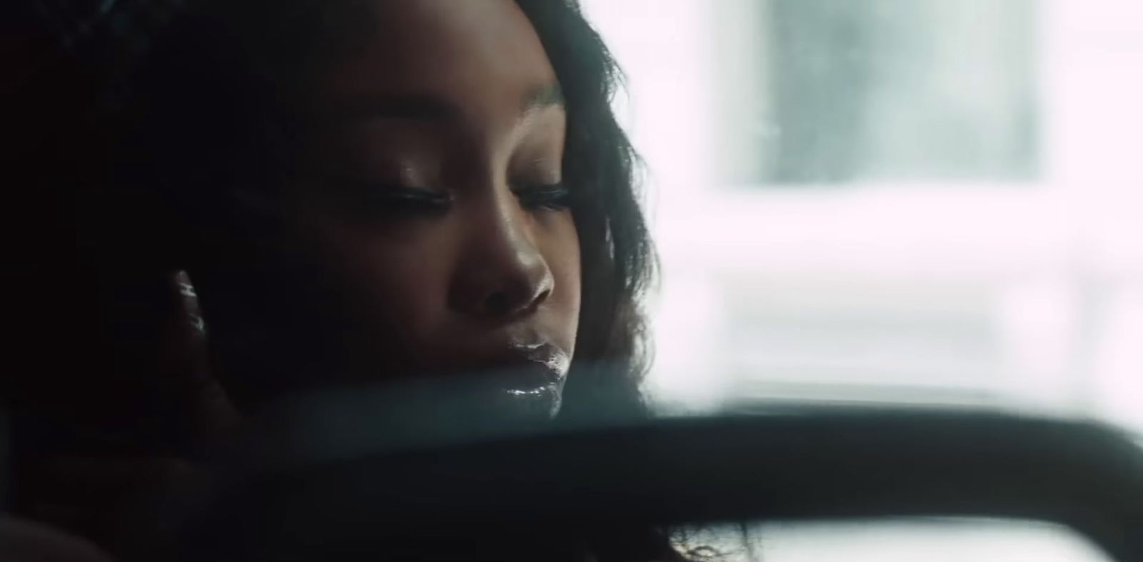 a woman talking on a cell phone in a car