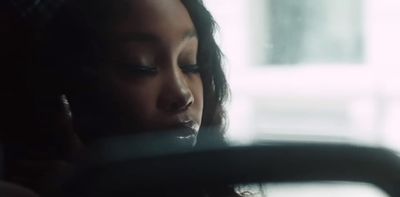 a woman talking on a cell phone in a car