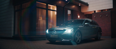 a car parked in front of a building at night