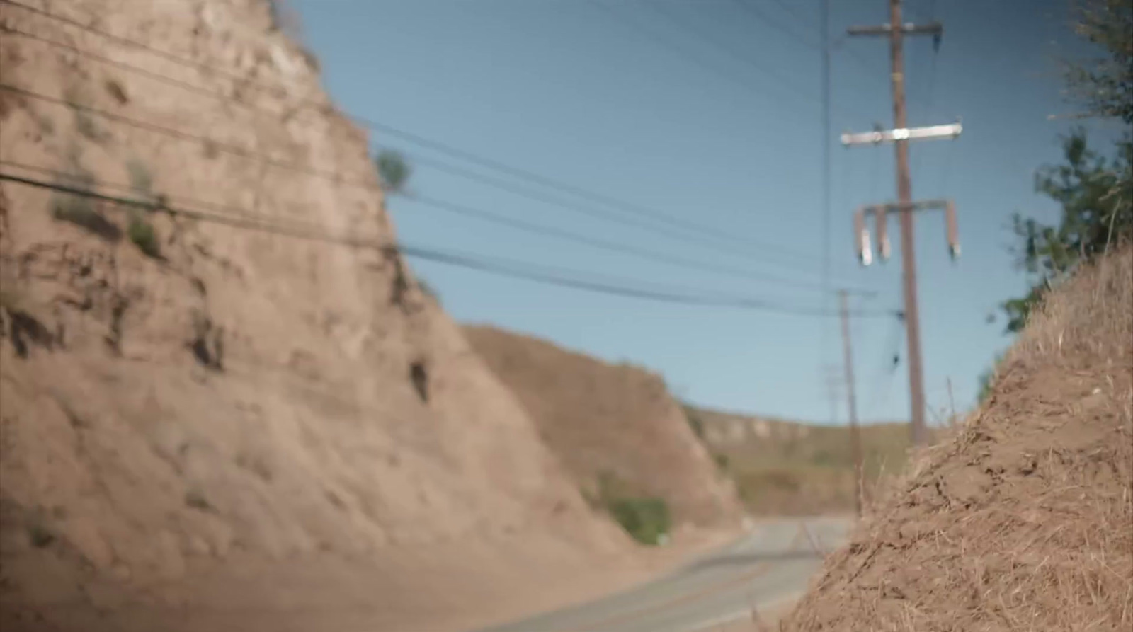 a blurry photo of a road and a hill