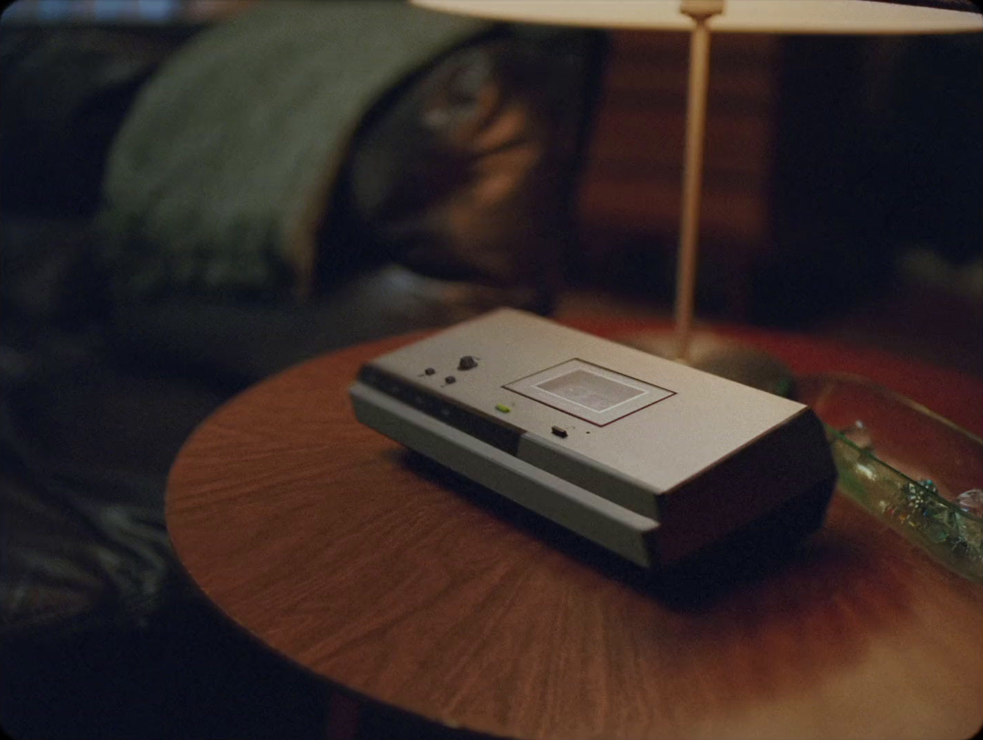 a small electronic device sitting on top of a wooden table