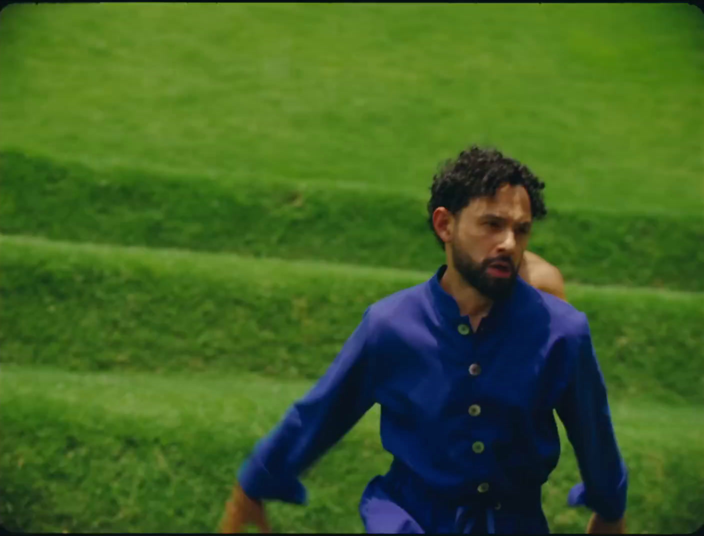 a man in a blue shirt is playing soccer