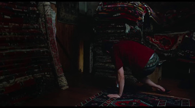 a person bending over on a rug in a room