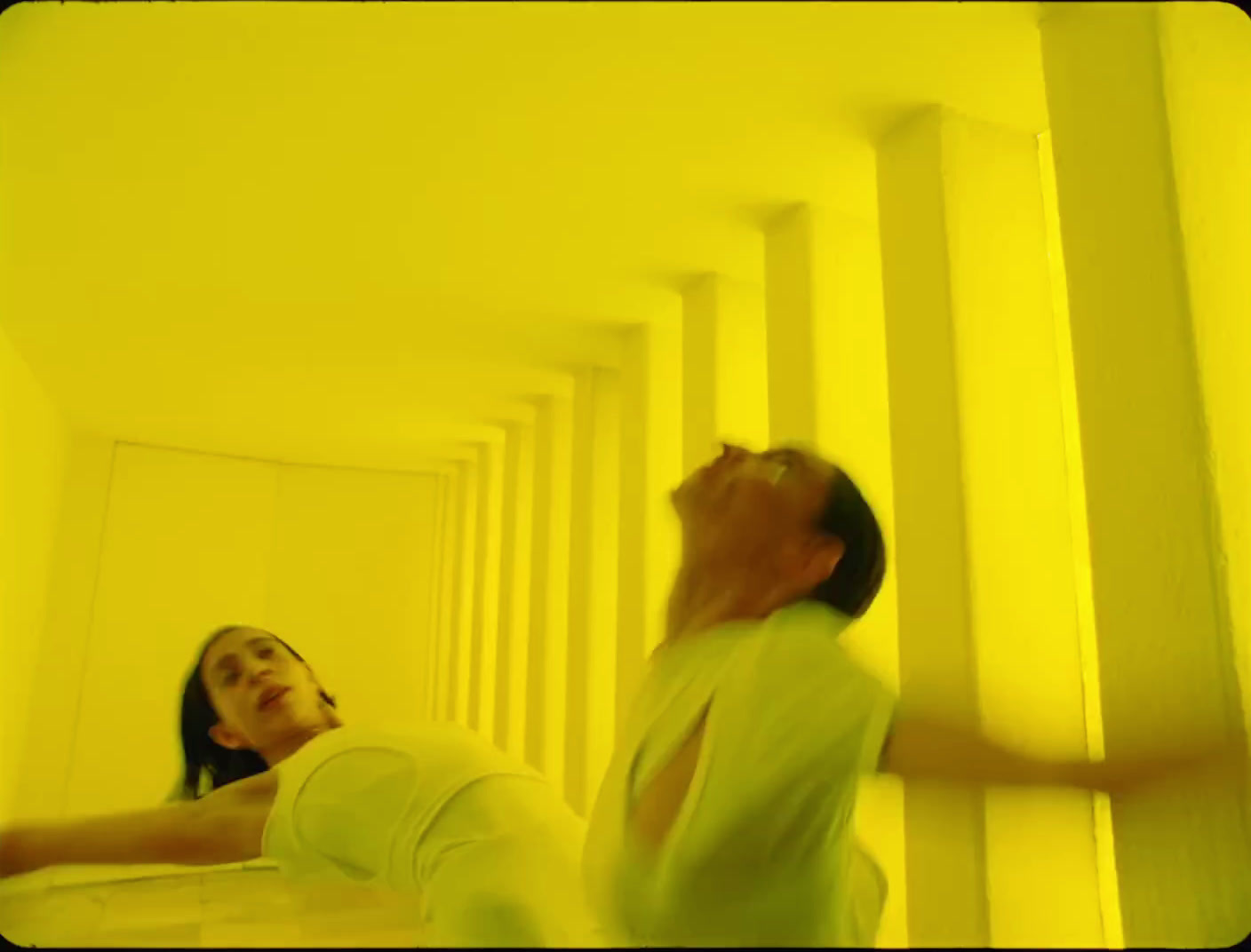 a man and a woman standing in a yellow room