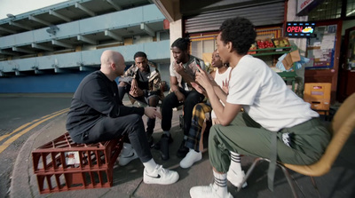 a group of men sitting around each other