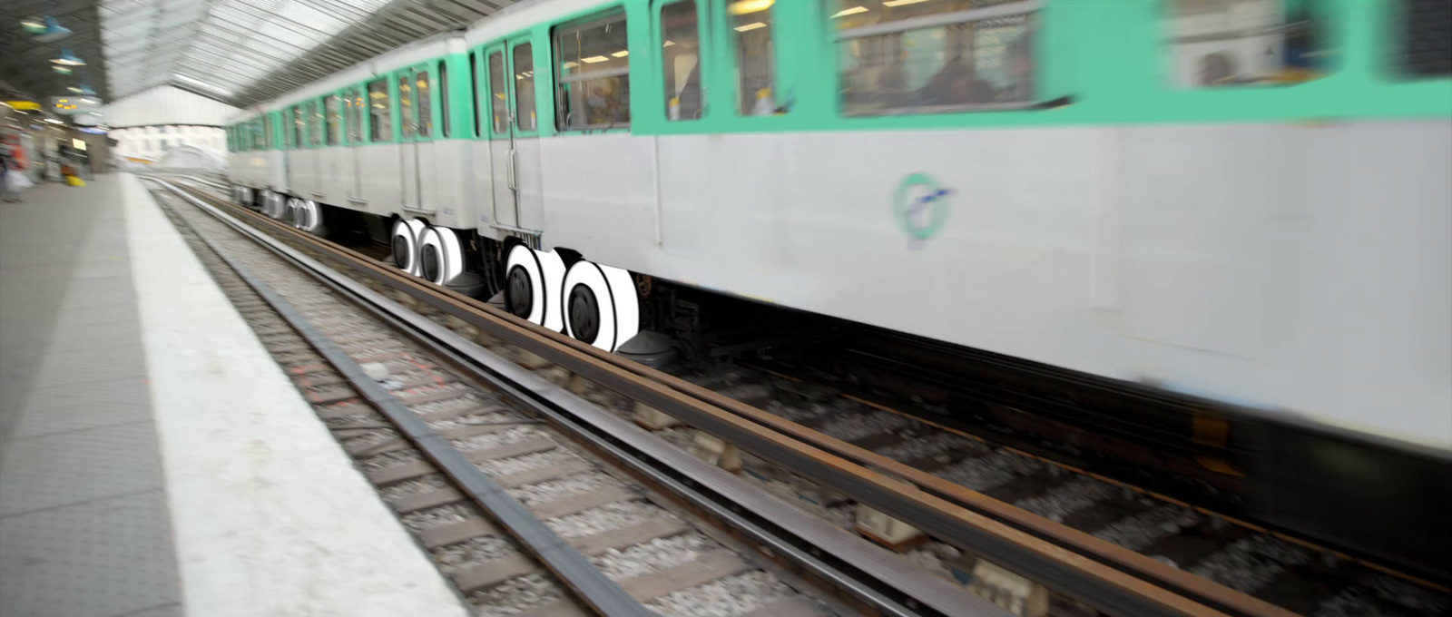 a green and white train traveling down train tracks