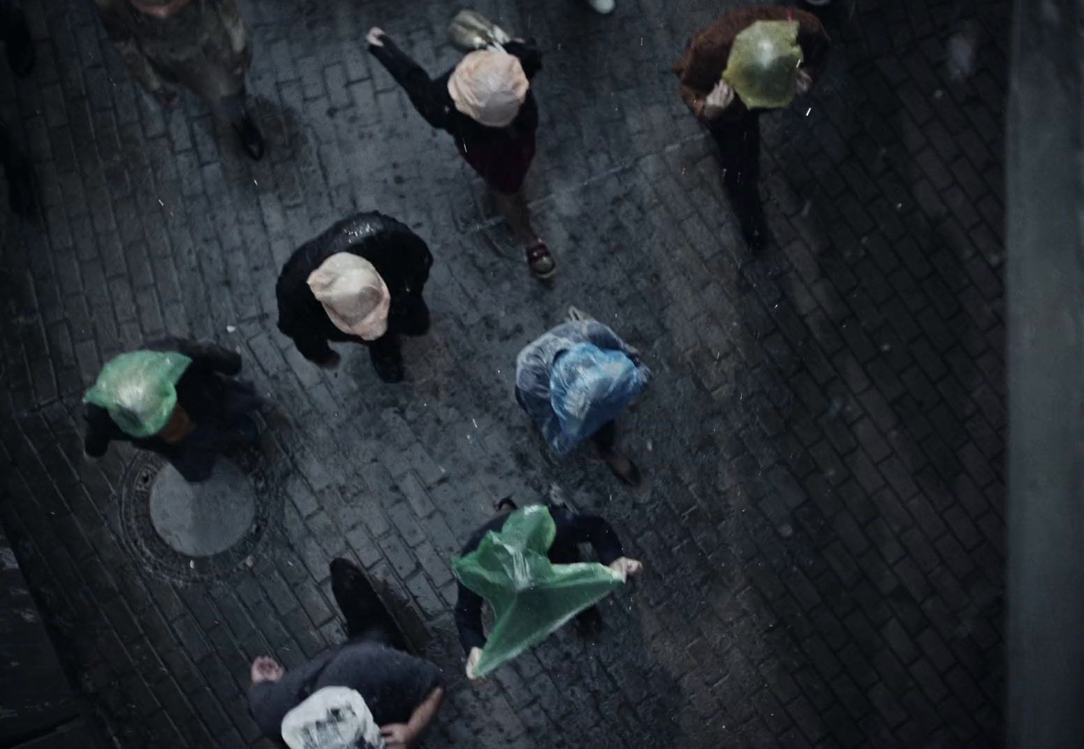 a group of people walking down a street holding umbrellas