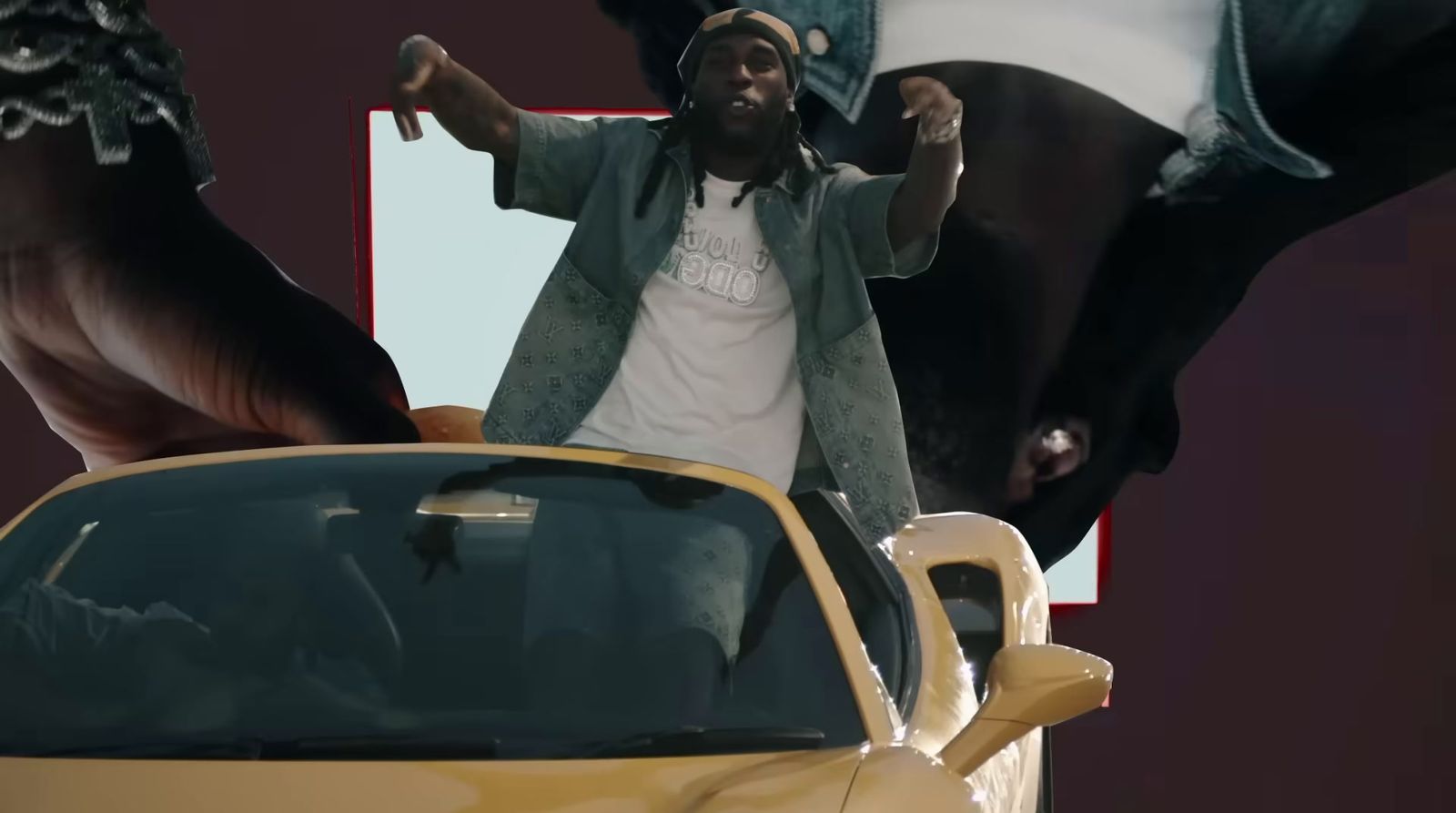 a man standing next to a yellow sports car