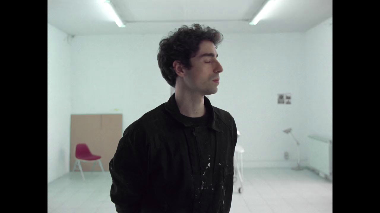 a man standing in a room with a black shirt on