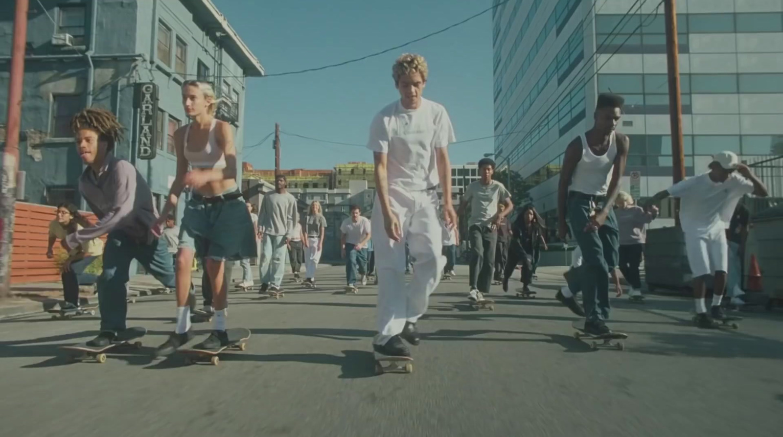 a group of people riding skateboards down a street