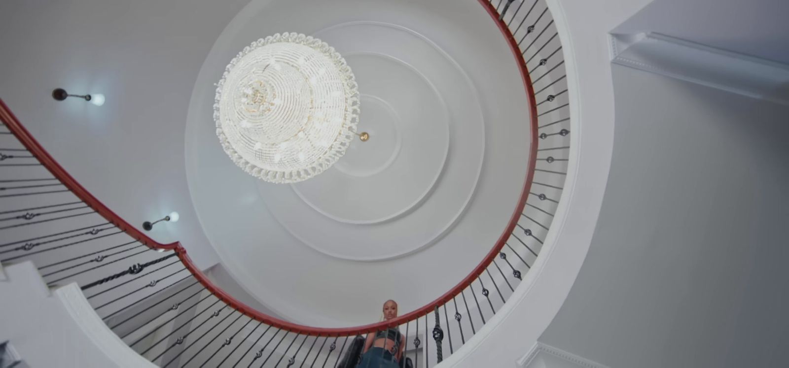 a person standing on a spiral staircase in a building