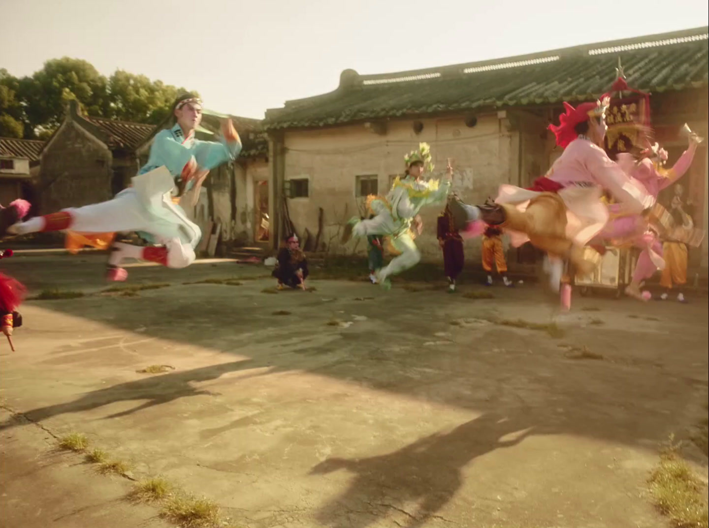 a group of people are dancing in a courtyard