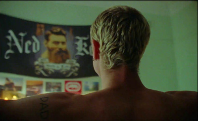 the back of a man's head with tattoos on it