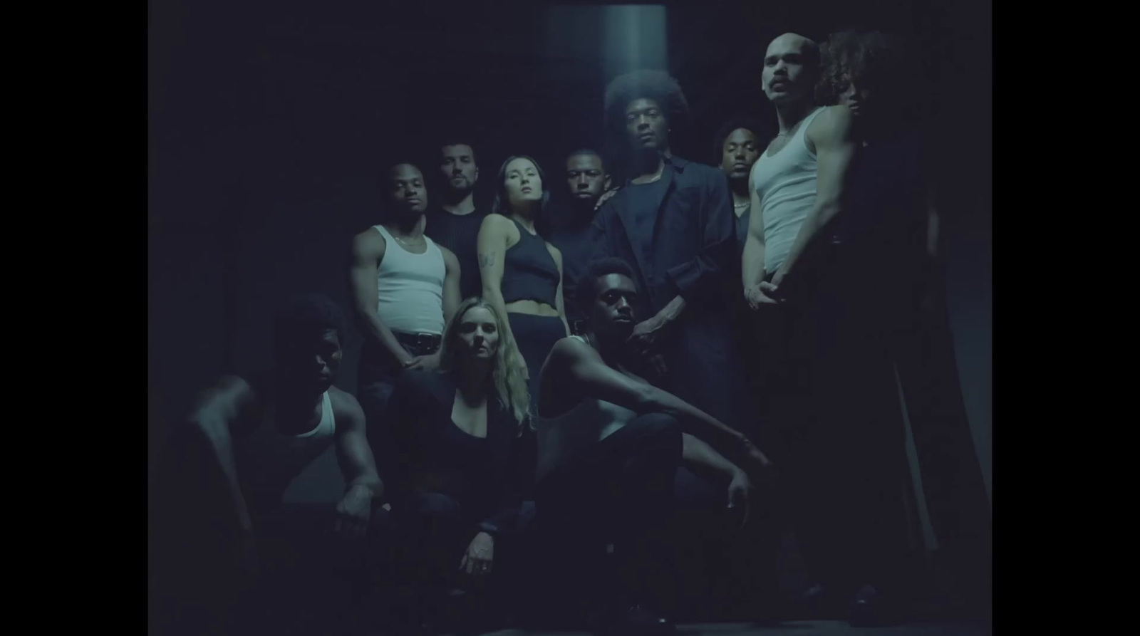 a group of people standing in a dark room