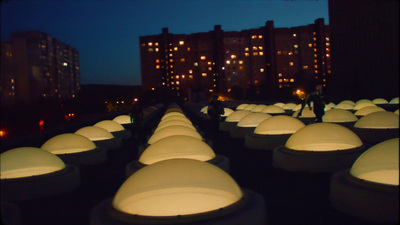 a row of white lights sitting in the middle of a street