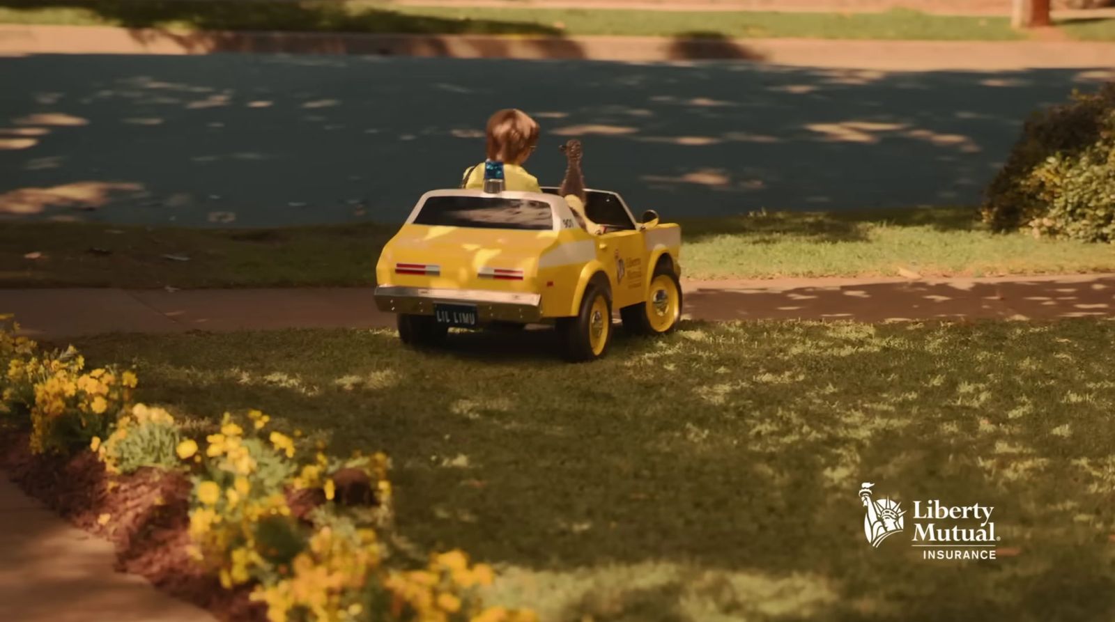 a little girl riding in a yellow toy car