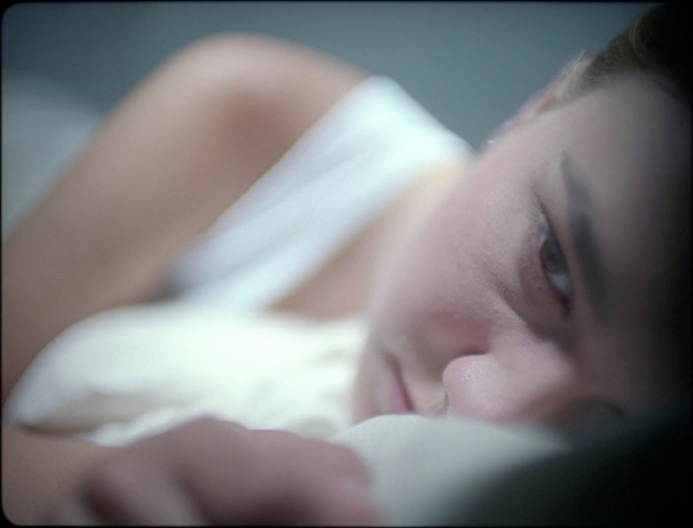 a close up of a person laying in a bed