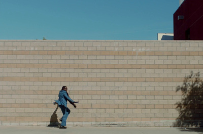 a man riding a skateboard down a sidewalk