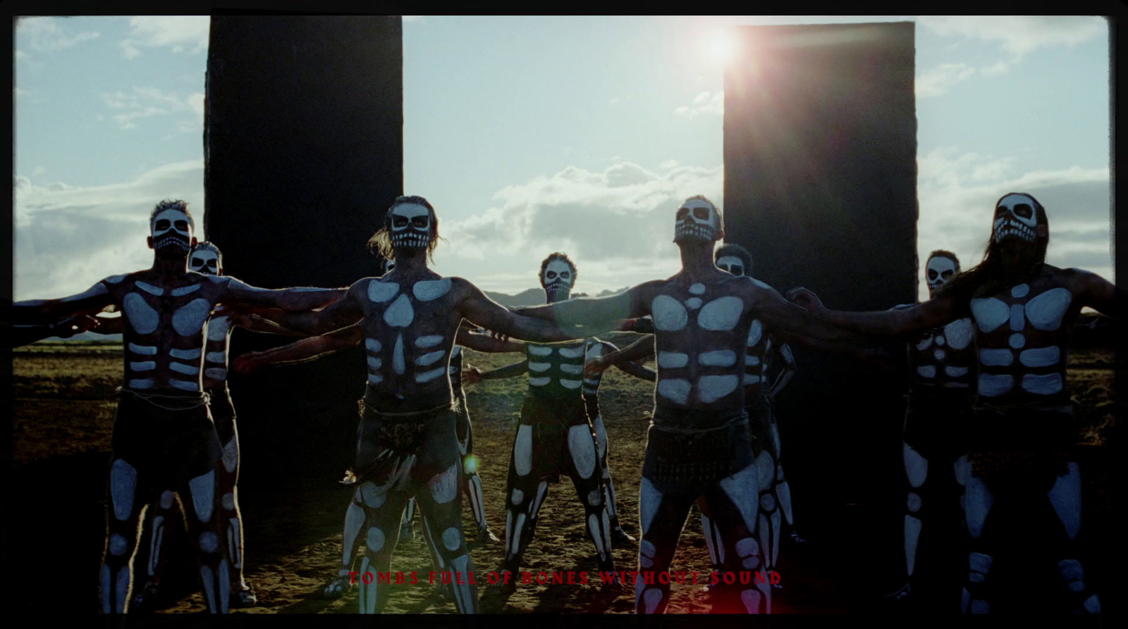 a group of men with painted body paint posing for a picture