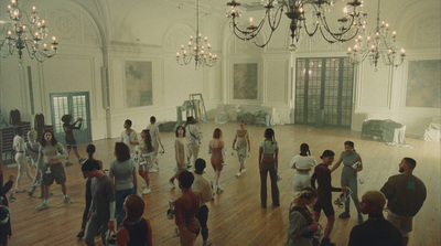 a group of people in a room with chandeliers