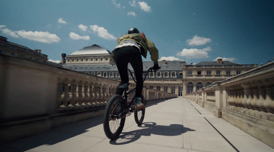 a person riding a bike on a bridge