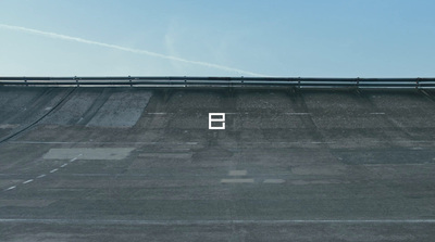 an empty parking lot with a sky background