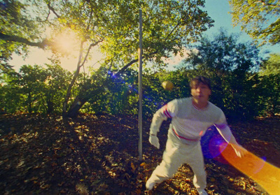 a man holding a frisbee in a wooded area