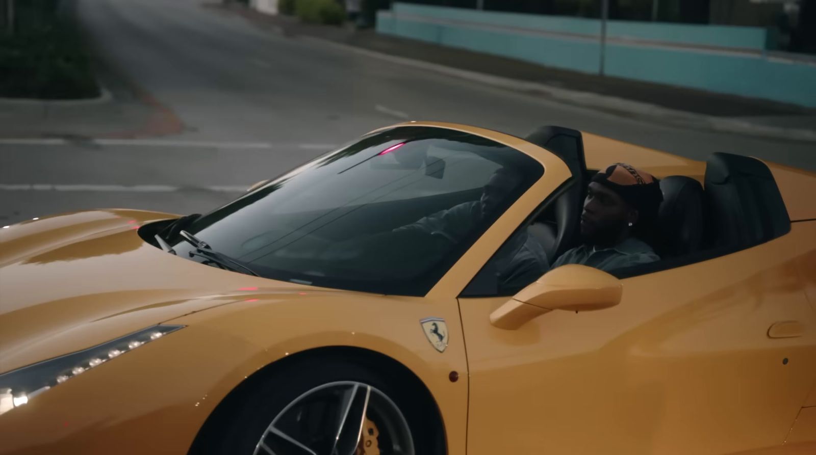 a man sitting in a yellow sports car