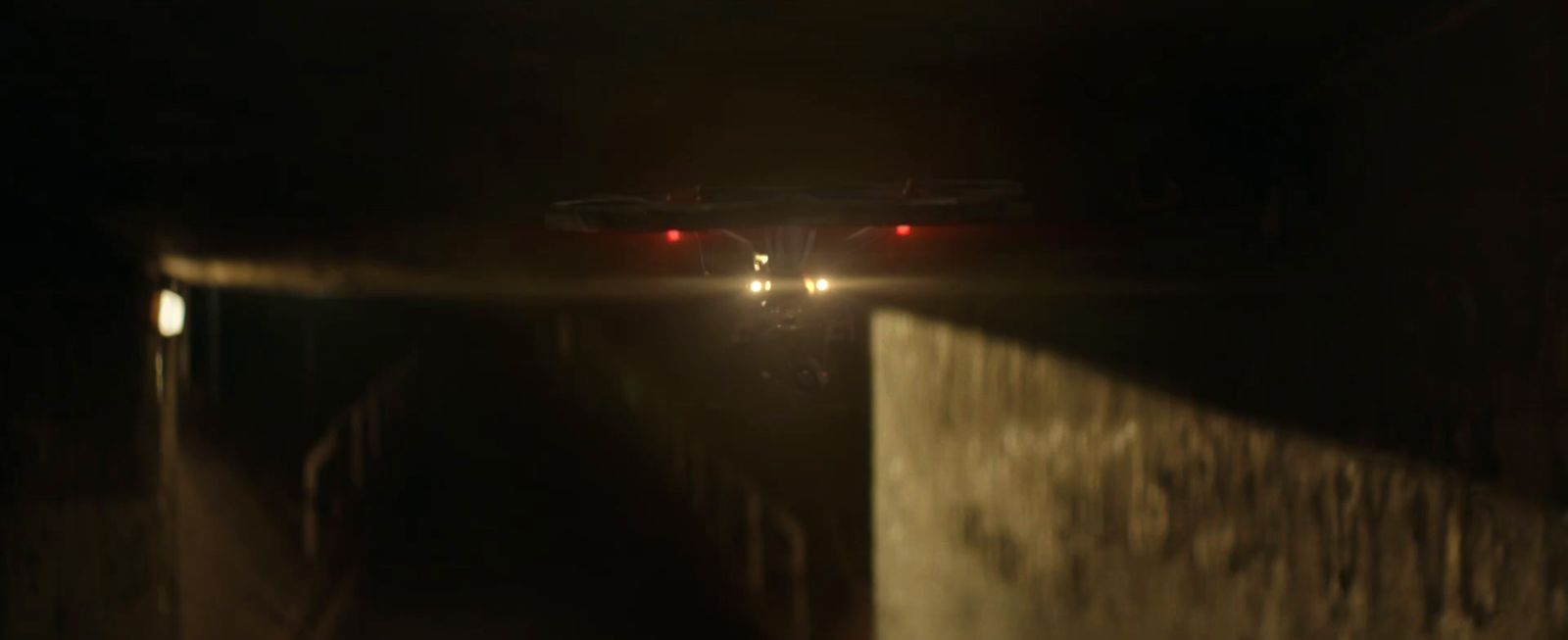 a car driving through a tunnel at night