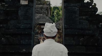 a man in a chef's hat standing in front of a doorway