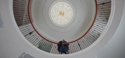 a couple of people that are standing in a spiral staircase