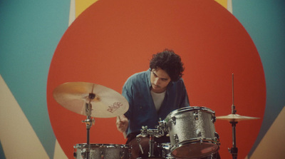 a man is playing drums on a stage