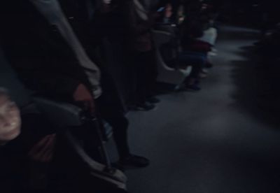 a group of people sitting on a bus at night