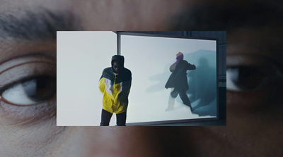 a man looking at a picture of a man in a yellow jacket