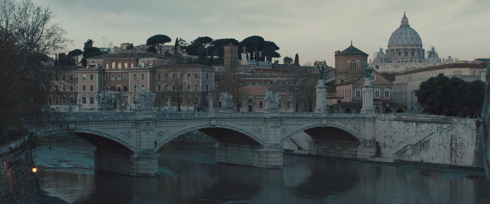 a bridge over a body of water with buildings in the background