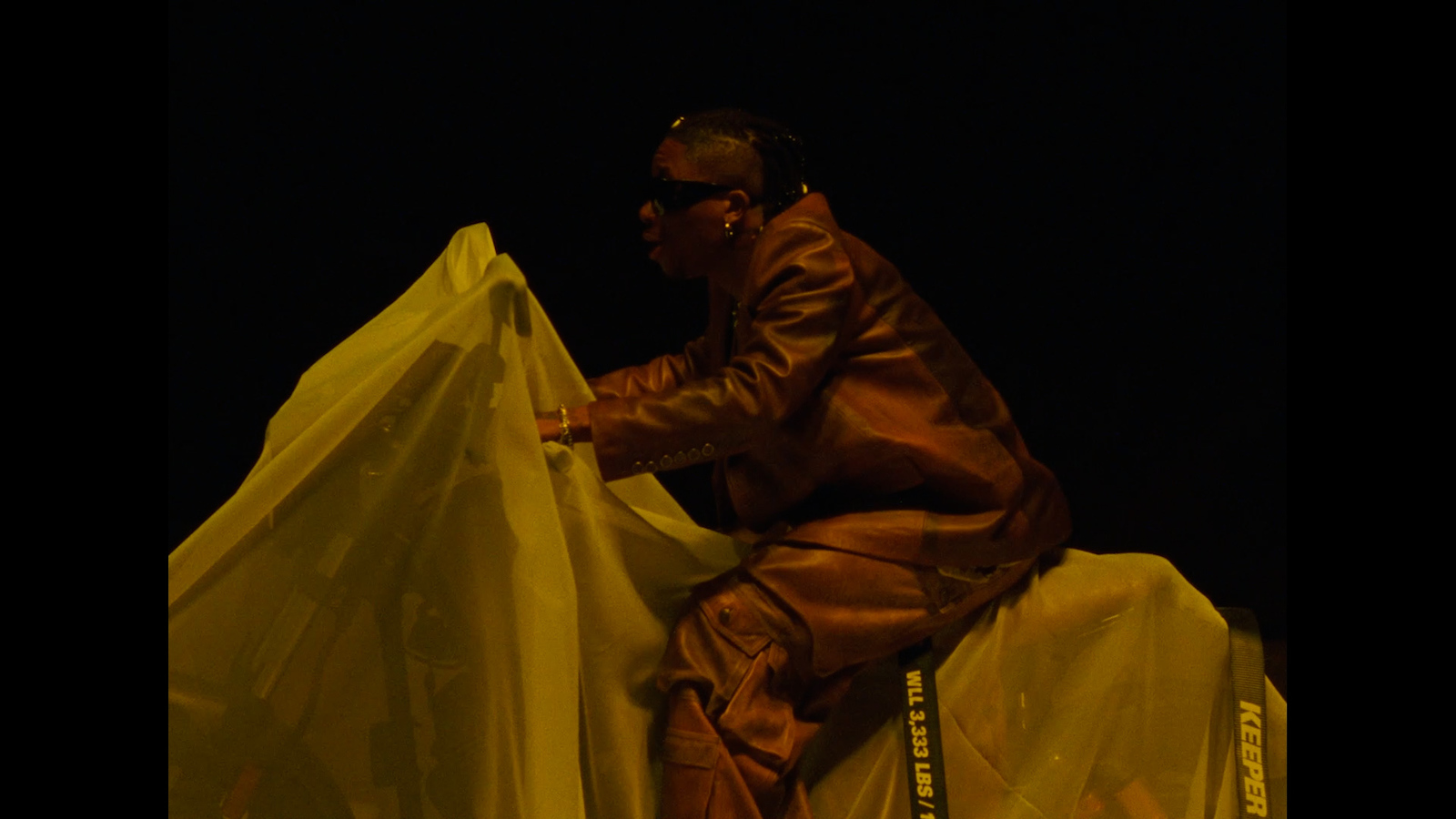 a man sitting on top of a plastic bag