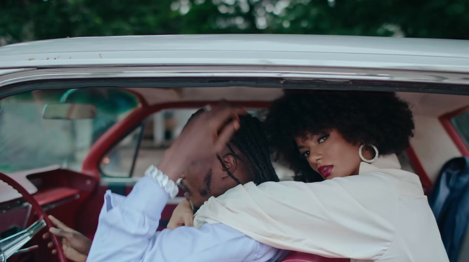 a man and a woman sitting in a car