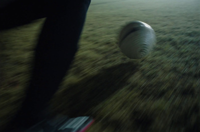 a blurry photo of a person kicking a soccer ball