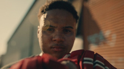 a close up of a person wearing a red shirt