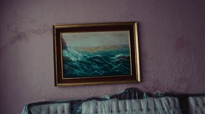 a painting hanging on a wall above a radiator