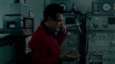 a man in a red jacket talking on a cell phone