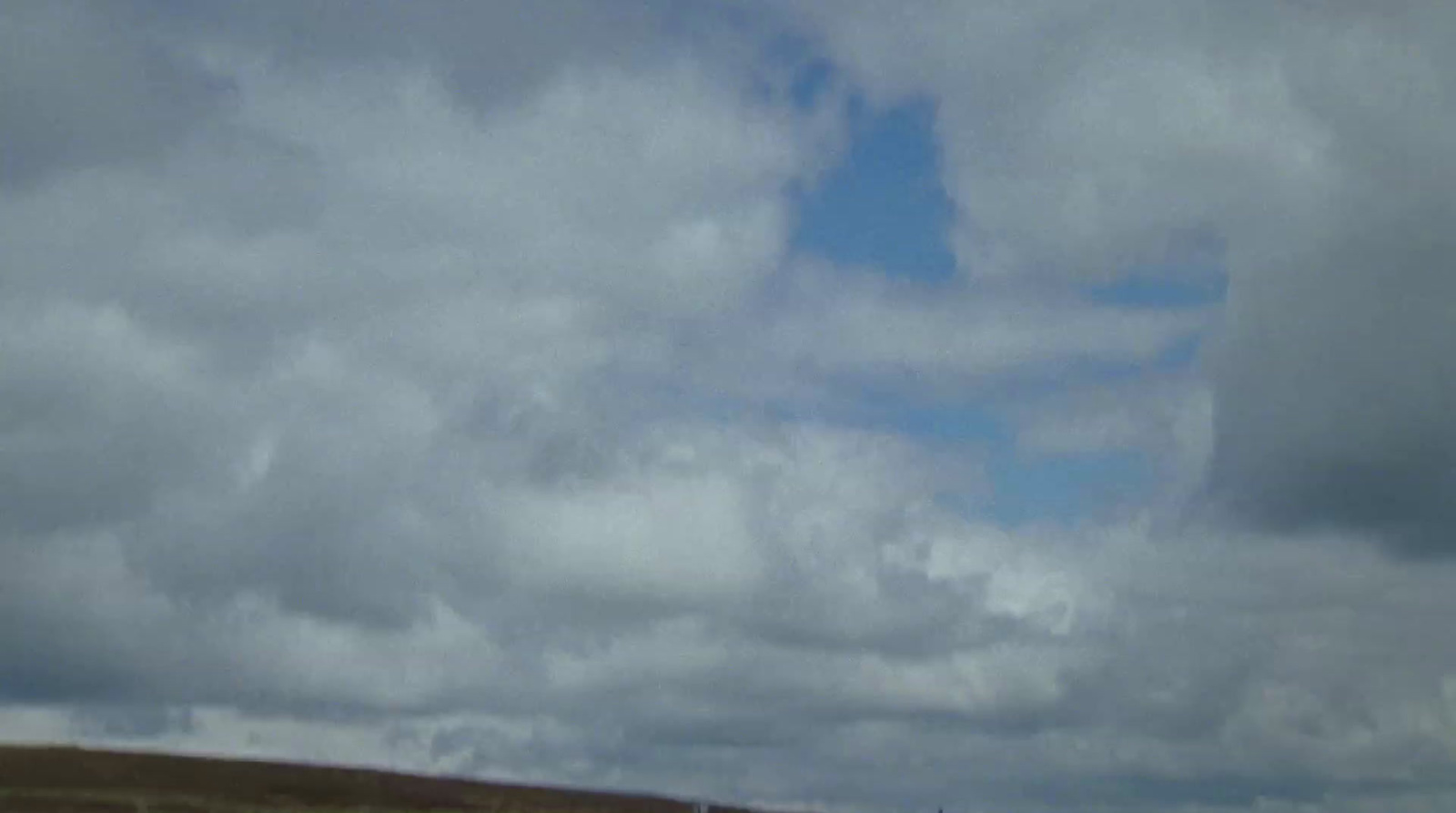 a person flying a kite on a cloudy day