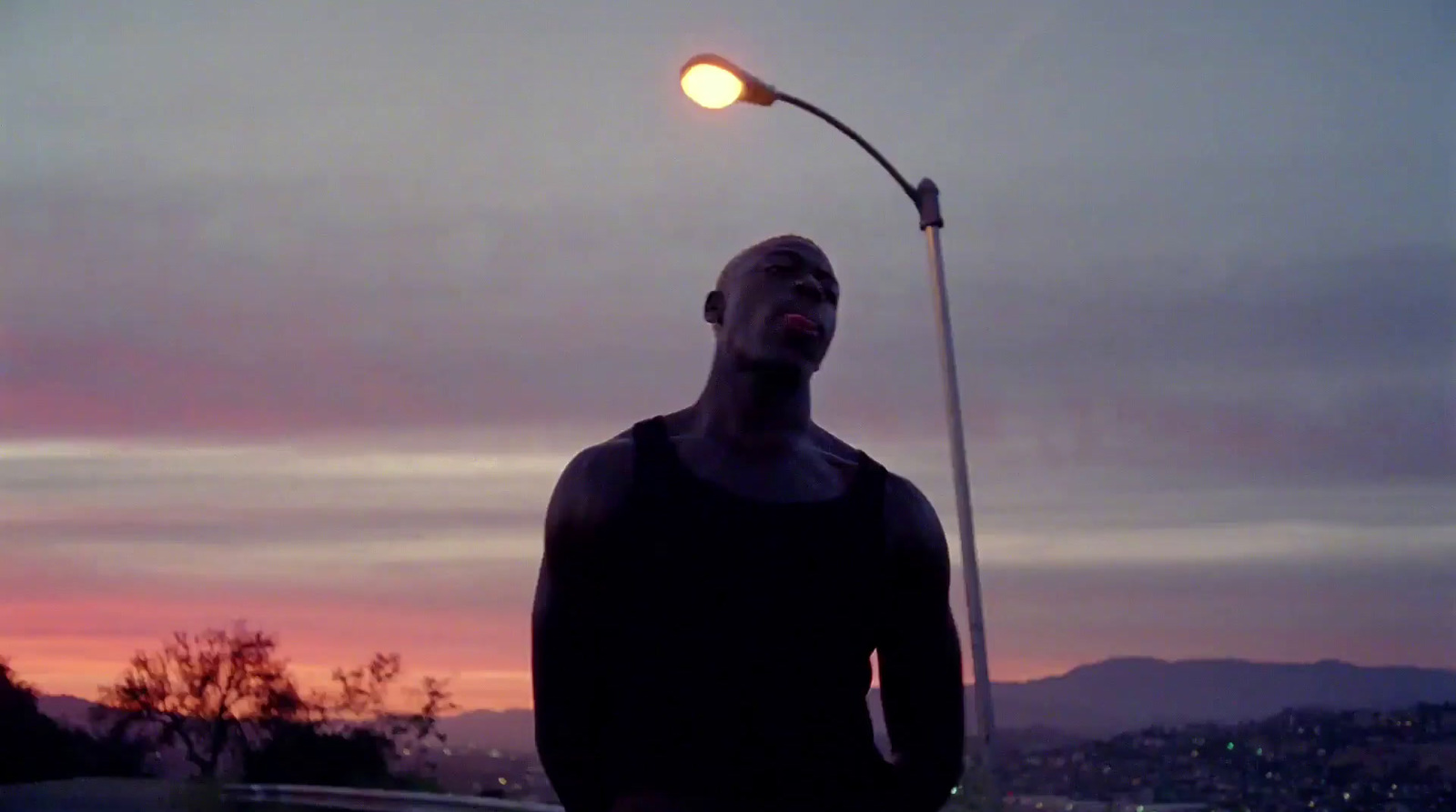 a man is standing under a street light