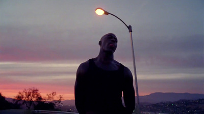 a man is standing under a street light