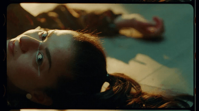 a woman laying on the ground with her eyes open