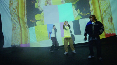 a group of people standing in front of a large screen